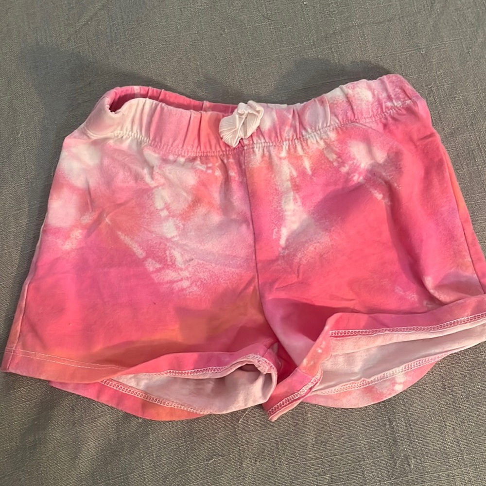 Children place tie dye shorts